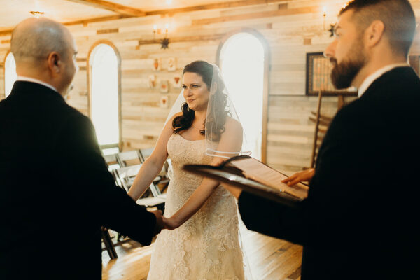 Couple exchanging vows in a rustic chapel elopement